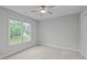 Bright bedroom with carpet floors, neutral walls, and a window providing natural light at 1208 Mossy Glade Cir, Apex, NC 27502