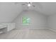 Spacious bedroom with built-in cabinets, a dormer window, and neutral carpet at 1208 Mossy Glade Cir, Apex, NC 27502