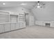 Open bonus room with multiple built-ins, carpeted floors, and a ceiling fan at 1208 Mossy Glade Cir, Apex, NC 27502