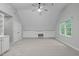 Bonus room with built-in shelving and cabinets, carpeted floors and a ceiling fan at 1208 Mossy Glade Cir, Apex, NC 27502