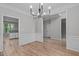 Bright and airy dining room with hardwood floors, decorative molding, and contemporary chandelier at 1208 Mossy Glade Cir, Apex, NC 27502
