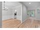 Elegant dining room with hardwood floors, wainscoting, and a modern chandelier at 1208 Mossy Glade Cir, Apex, NC 27502