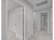 Bright hallway features multiple doors, neutral walls and carpet flooring at 1208 Mossy Glade Cir, Apex, NC 27502