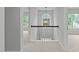 Upstairs hallway featuring neutral colors and a decorative light fixture at 1208 Mossy Glade Cir, Apex, NC 27502