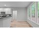 Bright kitchen with stainless appliances, white cabinets, and wood flooring at 1208 Mossy Glade Cir, Apex, NC 27502
