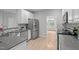 Kitchen with stainless steel appliances, gray countertops, and hardwood floors at 1208 Mossy Glade Cir, Apex, NC 27502