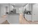 Kitchen with stainless appliances, grey countertops, and wood floors at 1208 Mossy Glade Cir, Apex, NC 27502
