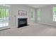 Bright living room with gray walls, light carpet, fireplace, and lots of light at 1208 Mossy Glade Cir, Apex, NC 27502