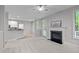 View of the kitchen and living room featuring fireplace and natural light at 1208 Mossy Glade Cir, Apex, NC 27502