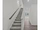 Staircase leading to the upper level with light gray carpet and gray wood-look floors at 1208 Solace Way, Rolesville, NC 27571