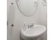 Bathroom featuring modern vessel sink, chrome faucet, oval mirror, and paper towel holder at 1213 Grenshaw Dr, Morrisville, NC 27560