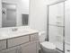 Updated bathroom with grey cabinets and a stand-up shower with glass doors at 1213 Grenshaw Dr, Morrisville, NC 27560