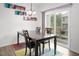 Bright dining room with colorful wall art and sliding glass doors to a patio area at 1213 Grenshaw Dr, Morrisville, NC 27560