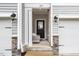 Inviting townhome entryway with neutral chair, gray siding, and a secure front door at 1213 Grenshaw Dr, Morrisville, NC 27560