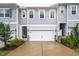 Charming townhome showcasing gray siding, a two-car garage, and manicured landscaping at 1213 Grenshaw Dr, Morrisville, NC 27560
