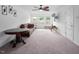 Spacious living room with neutral carpet, white walls, ceiling fan and multiple windows at 1213 Grenshaw Dr, Morrisville, NC 27560