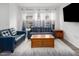 Cozy living room with blue sofas, wood accents, and plenty of natural light at 1213 Grenshaw Dr, Morrisville, NC 27560