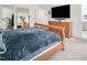 The main bedroom offers a large dresser, mounted TV, and walk-in closet at 1213 Grenshaw Dr, Morrisville, NC 27560