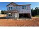 Unfinished two-story home with an attached two-car garage and a covered front porch at 135 Cordoba Dr, Franklinton, NC 27525