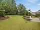 Spacious backyard featuring a stone patio with seating and a large, well-kept lawn at 136 Shadow Hawk Dr, Durham, NC 27713
