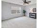 Spacious bedroom with a ceiling fan and a large window offering great natural light at 136 Shadow Hawk Dr, Durham, NC 27713
