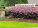Community entrance sign with stone accents and lush landscaping at 136 Shadow Hawk Dr, Durham, NC 27713