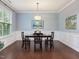 Dining area with hardwood floors, decorative chandelier and an abundance of natural light at 136 Shadow Hawk Dr, Durham, NC 27713