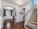Grand foyer boasts hardwood floors, an arched doorway, and elegant staircase leading to upper level at 136 Shadow Hawk Dr, Durham, NC 27713