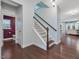 Entryway with hardwood floors and staircase, next to half-bath at 136 Shadow Hawk Dr, Durham, NC 27713