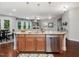 Open kitchen with granite countertops, stainless steel appliances connected to an adjacent living space at 136 Shadow Hawk Dr, Durham, NC 27713