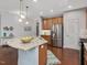 Spacious kitchen with granite countertops, stainless steel appliances and dark hardwood floors at 136 Shadow Hawk Dr, Durham, NC 27713