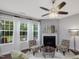 Bright living room with a cozy fireplace and multiple windows dressed with white sheer curtains at 136 Shadow Hawk Dr, Durham, NC 27713
