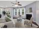 Bright living room with a cozy fireplace and multiple windows dressed with white sheer curtains at 136 Shadow Hawk Dr, Durham, NC 27713