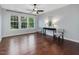 Spacious living room with hardwood floors, large windows, and stylish decor at 136 Shadow Hawk Dr, Durham, NC 27713