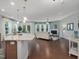 Open concept living space features dark hardwood floors and a fireplace, adjacent to the kitchen and dining area at 136 Shadow Hawk Dr, Durham, NC 27713