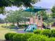 Playground with climbing structure, slide, and covered seating at 136 Shadow Hawk Dr, Durham, NC 27713