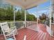Inviting screened porch with rocking chairs, adjacent to an open deck and backyard at 136 Shadow Hawk Dr, Durham, NC 27713
