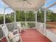 Relaxing screened porch featuring a ceiling fan, rocking chairs, and a view of the backyard at 136 Shadow Hawk Dr, Durham, NC 27713
