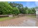 Large wooden deck is perfect for entertaining while overlooking fenced backyard with mature trees at 139 Carriage Hill Dr, Stem, NC 27581