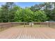 Large wood deck overlooking fenced-in yard and mature trees provides a serene outdoor living space at 139 Carriage Hill Dr, Stem, NC 27581