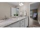 Bathroom features dual sinks with granite counters, white cabinets, large mirror, and neutral colored walls at 139 Carriage Hill Dr, Stem, NC 27581