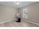 This cozy bedroom has neutral walls and modern flooring with a window allowing plenty of natural light at 139 Carriage Hill Dr, Stem, NC 27581