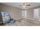 Bright bedroom featuring wood-look floors, neutral walls, and a ceiling fan at 139 Carriage Hill Dr, Stem, NC 27581