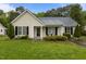 Charming single-story home with light siding, black shutters, and a well-maintained lawn at 139 Carriage Hill Dr, Stem, NC 27581