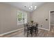 Eat-in kitchen features a black kitchen table with neutral colored walls and a large window at 139 Carriage Hill Dr, Stem, NC 27581