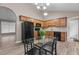 Open-concept kitchen includes a black refrigerator and range oven, wood cabinets, and granite countertops at 139 Carriage Hill Dr, Stem, NC 27581