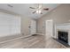Bright living room showcasing wood-look floors, vaulted ceilings, and natural light at 139 Carriage Hill Dr, Stem, NC 27581