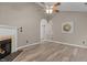 Inviting living room with a fireplace, vaulted ceiling, and wood-look flooring at 139 Carriage Hill Dr, Stem, NC 27581