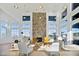 Elegant living space with stone fireplace, large windows, comfortable seating, and stylish lighting fixtures at 1633 Goldfinch Perch Ln, Knightdale, NC 27545