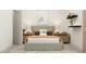 Cozy bedroom featuring neutral decor, bedside tables with lamps, and decorative shelving above the bed at 1637 Goldfinch Perch Ln, Knightdale, NC 27545